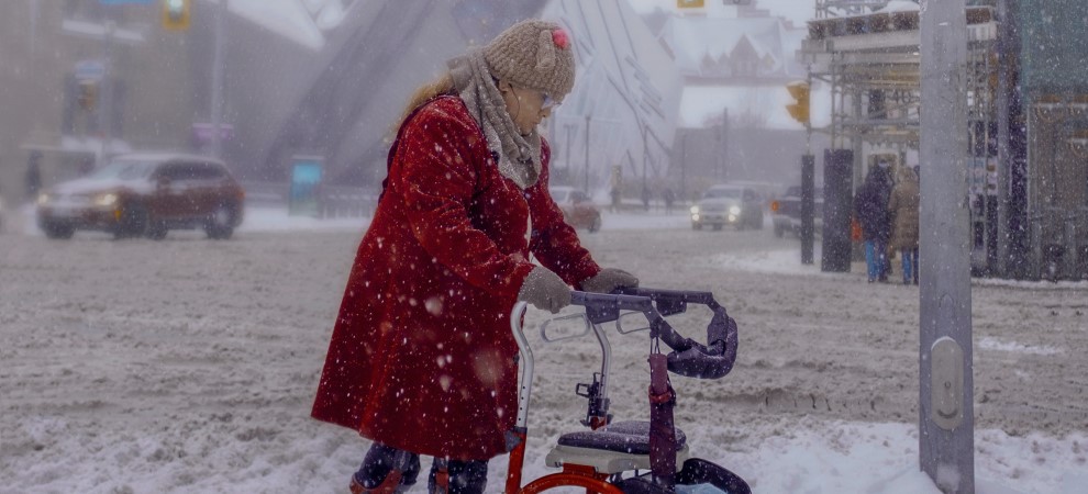 Elderly lady using walker in the snow