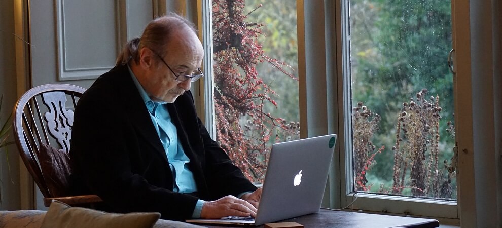 elderly man learning to use computer as part of digital inclusion