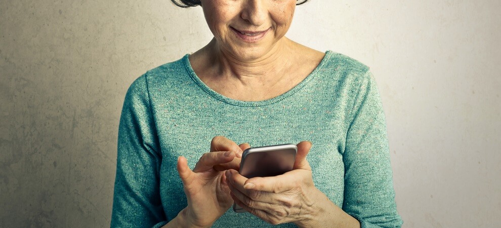 elderly woman using a phone, an example of affordable gadgets