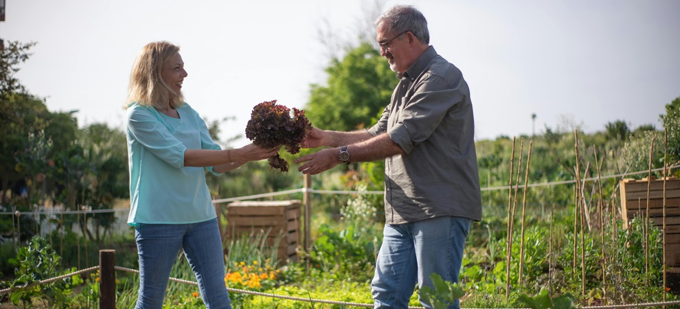 two older people enjoying the health benefits of gardening